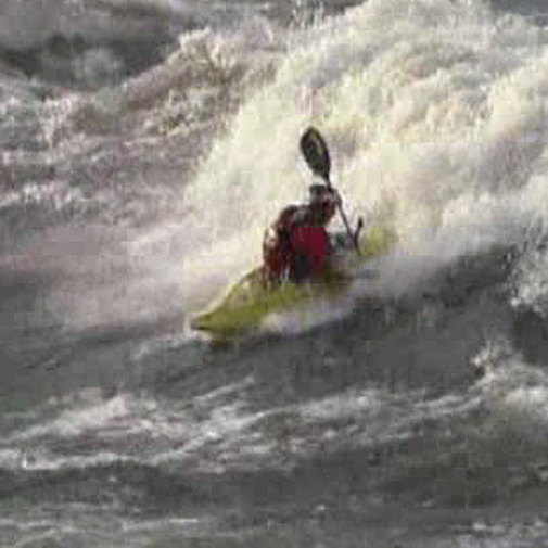 An adventurous kayaker defies the big waves