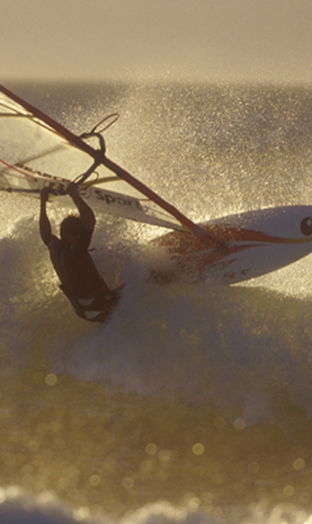 Windsurfer enjoying the waves on his windsurfing !